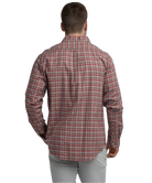 Man wearing a red and gray plaid shirt on a white background