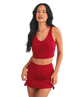 Woman wearing a red sports bra and skirt set on a white background