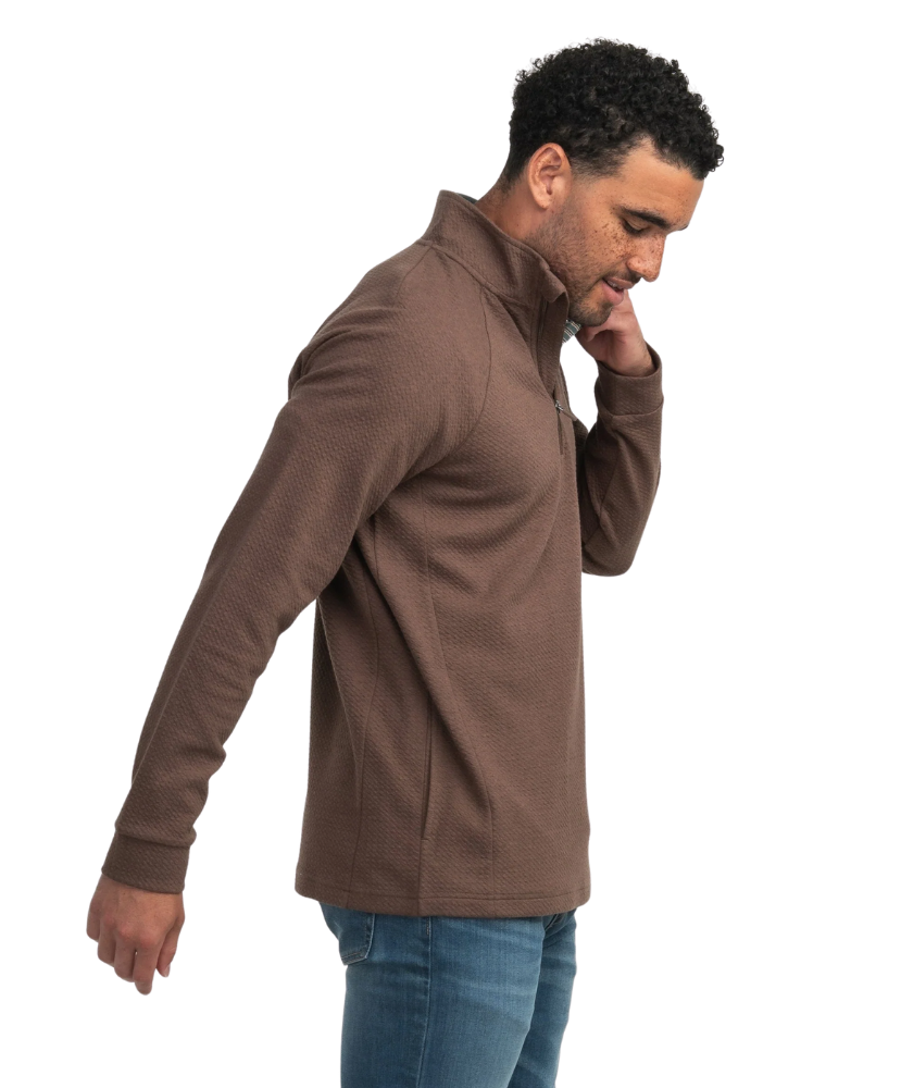 Man wearing a brown jacket and blue jeans on a white background