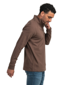 Man wearing a brown jacket and blue jeans on a white background