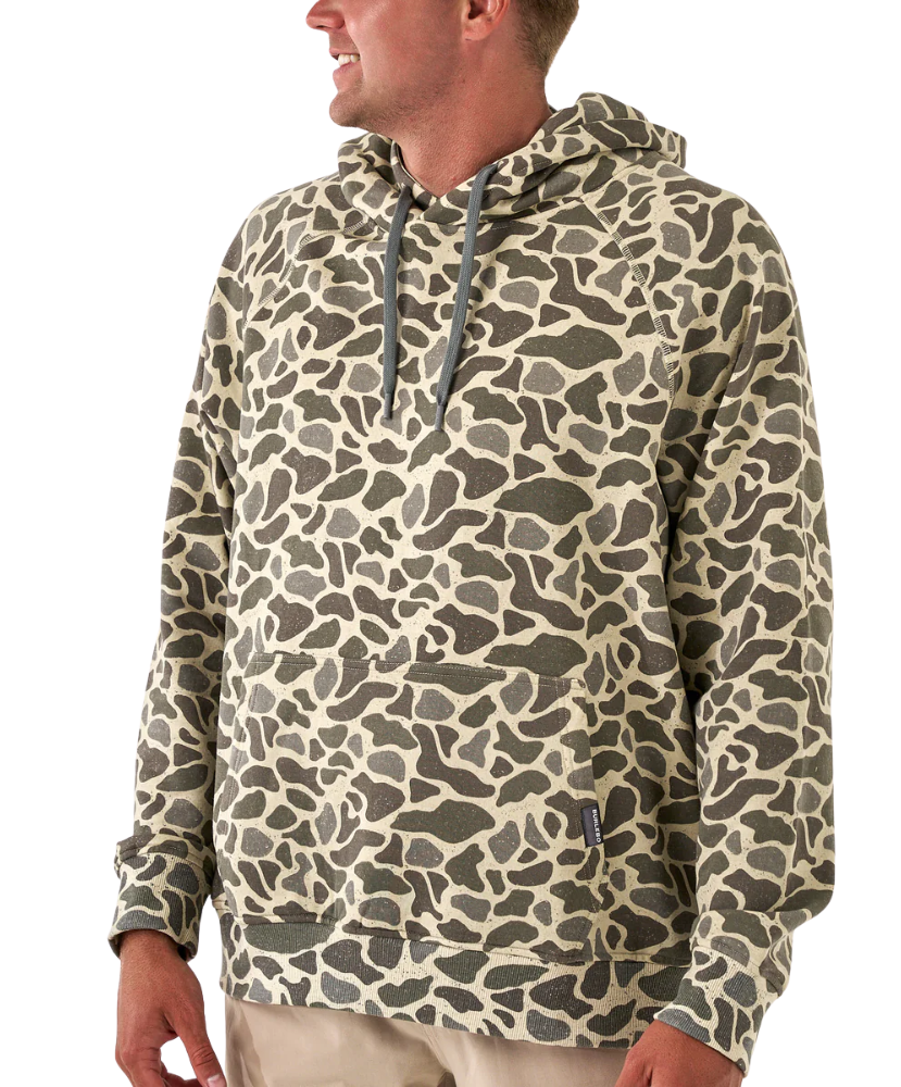 Camouflage-patterned hoodie worn by a person on a white background