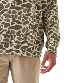 Camouflage-patterned shirt worn by a person on a white background