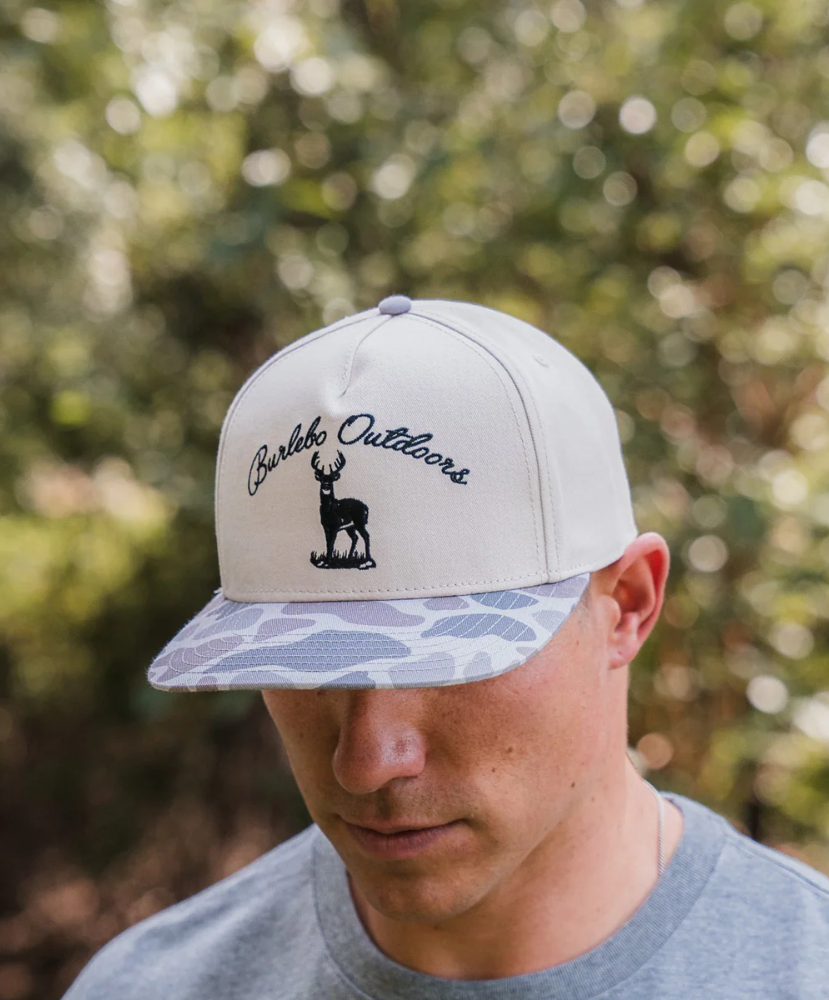 Person wearing a cap with 'Barbeque Outdoors' logo outdoors