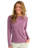A woman wearing a long-sleeve purple Nuk Fishing shirt with a pink logo on the chest, paired with light beige pants, set against a plain white background.