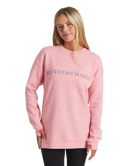 Woman wearing a pink sweatshirt with 'Southern Marsh' logo on a white background