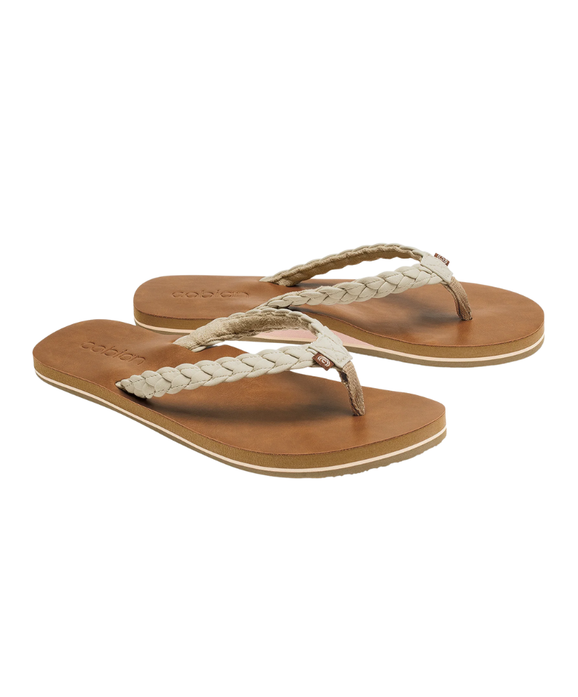 Pair of tan sandals with braided straps on a white background