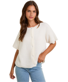Woman wearing a white blouse and blue jeans on a white background