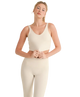 Woman wearing a beige tank top and pants on a white background