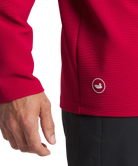 Man wearing a crimson pullover on a white background