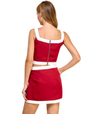 Red dress with white accents on a white background