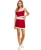 Woman wearing a red and white dress on a white background