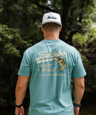 Person wearing a blue t-shirt with a largemouth bass and 'Burlebo Bait + Rigs' branding and graphics.