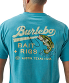 Person wearing a blue t-shirt with a largemouth bass and 'Burlebo Bait + Rigs' branding and graphics.