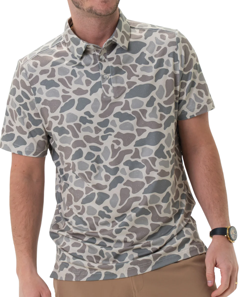 Man wearing a camouflage-patterned polo shirt on a white background