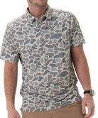 Man wearing a camouflage-patterned polo shirt on a white background