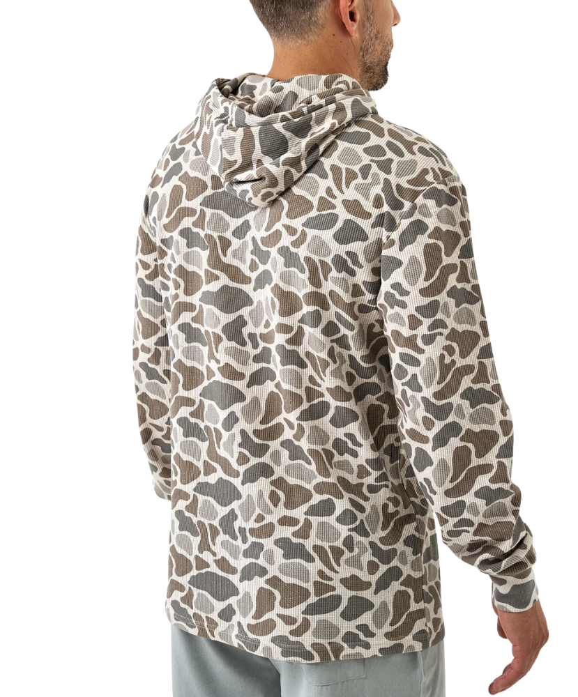 Person wearing a camouflage-patterned hoodie on a white background