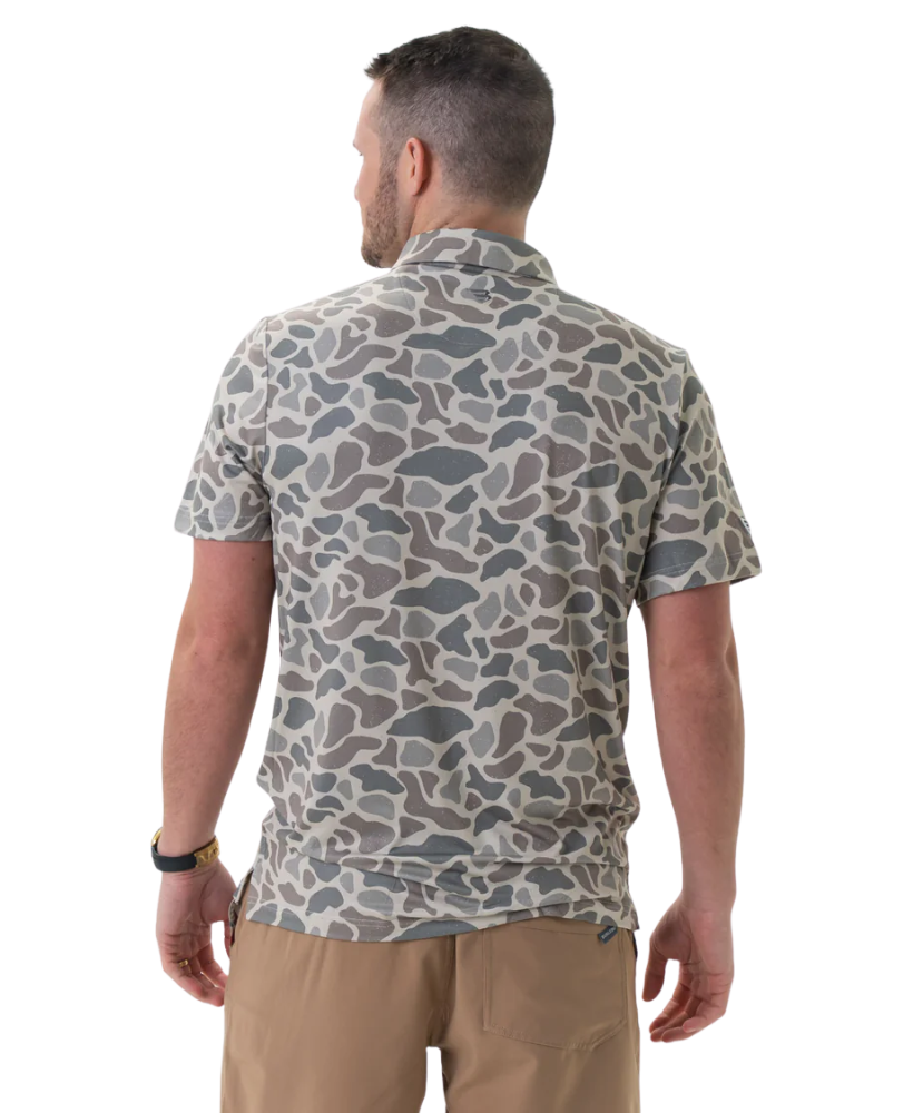 Man wearing a camouflage-patterned shirt on a white background