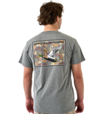 Man wearing a gray t-shirt with a mallard duck design and 'Burlebo Outdoors' branding on the back.