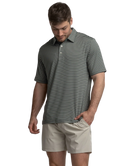 Man wearing a striped polo shirt and beige shorts on a white background