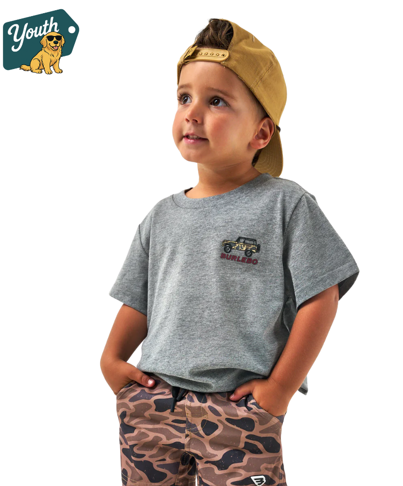 Child wearing a gray t-shirt with a jeep Burlebo logo and camouflage pants, standing against a white background.