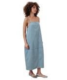 Woman wearing a light blue dress on a white background