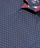 Close-up of a golf cart and palm tree patterned polo shirt with a visible brand label.