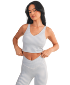 Woman wearing a light blue and white GINGHAM checkered tank on a white background