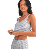 Woman wearing a light blue and white GINGHAM checkered tank on a white background