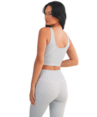 Woman wearing a light blue and white GINGHAM checkered tank on a white background