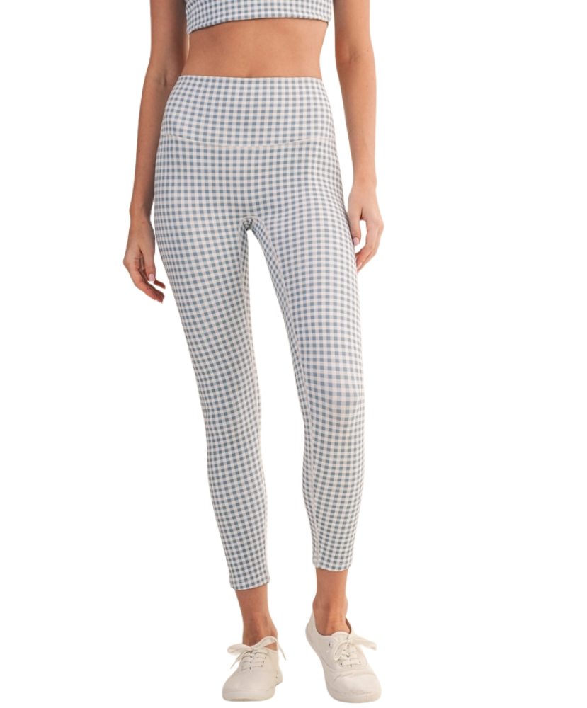 Person wearing blue and white gingham checkered leggings outfit on a white background
