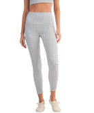 Person wearing blue and white gingham checkered leggings outfit on a white background