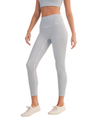 Person wearing blue and white gingham checkered outfit with leggings and a top on a white background