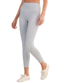 Person wearing blue and white gingham checkered outfit with leggings and a top on a white background