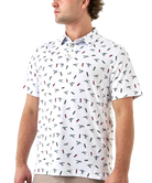 Man wearing a white polo shirt with small colorful ducks and shotgun shells patterns on a white background