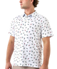 Man wearing a white polo shirt with small colorful ducks and shotgun shells patterns on a white background