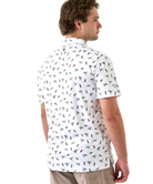Man wearing a white polo shirt with small colorful ducks and shotgun shells patterns on a white background