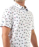 Man wearing a white polo shirt with small colorful ducks and shotgun shells patterns on a white background