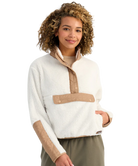 Woman wearing a white and beige fleece pullover on a white background