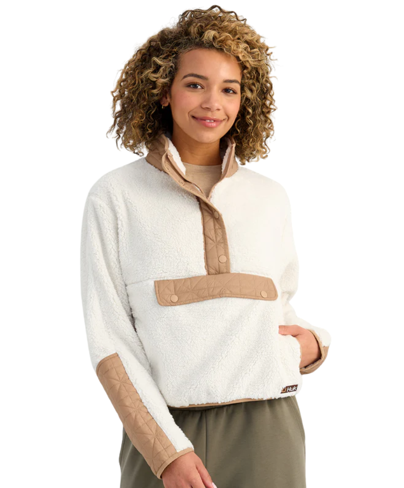 Woman wearing a white and beige fleece pullover on a white background