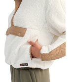 Woman wearing a white and beige fleece pullover on a white background
