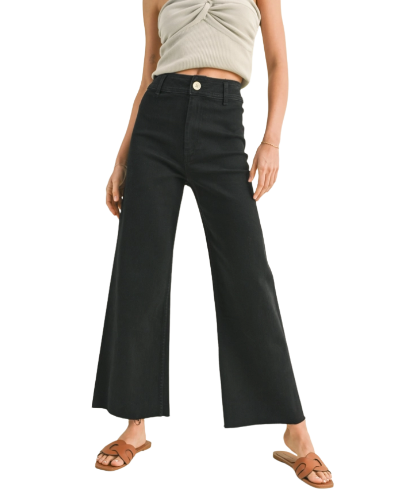 FADE BLACK pants worn by a woman on a white background