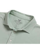 Light green Beach & Barn polo shirt with a pocket on a white background
