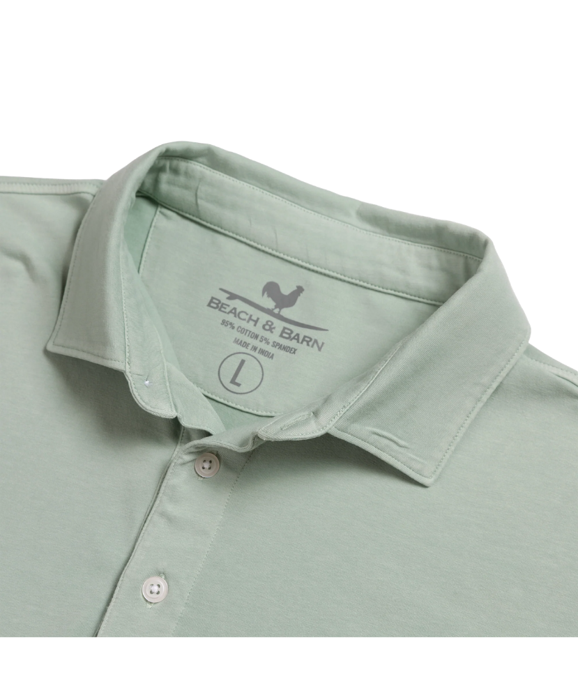 Light green Beach & Barn polo shirt with a pocket on a white background