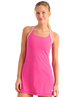 Woman wearing an athletic HUK pink dress on a white background