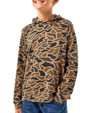 A child wearing a long-sleeve hooded shirt with an allover camouflage-style pattern in tan, brown, and black, paired with blue jeans against a plain white background.