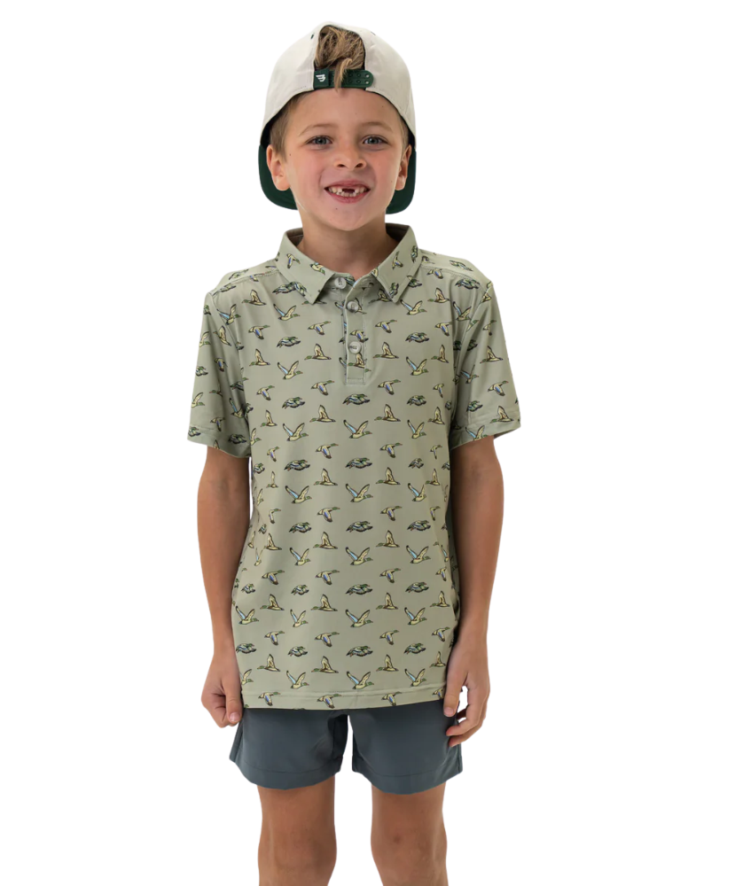 Child wearing a flying duck patterned shirt and cap on a white background