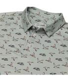 Green polo shirt with duck pattern on a white background