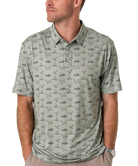 Man wearing a flying duck patterned green polo shirt on a white background