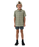 Child wearing a flying duck patterned shirt and shorts on a white background