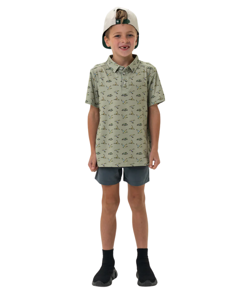 Child wearing a flying duck patterned shirt and shorts on a white background